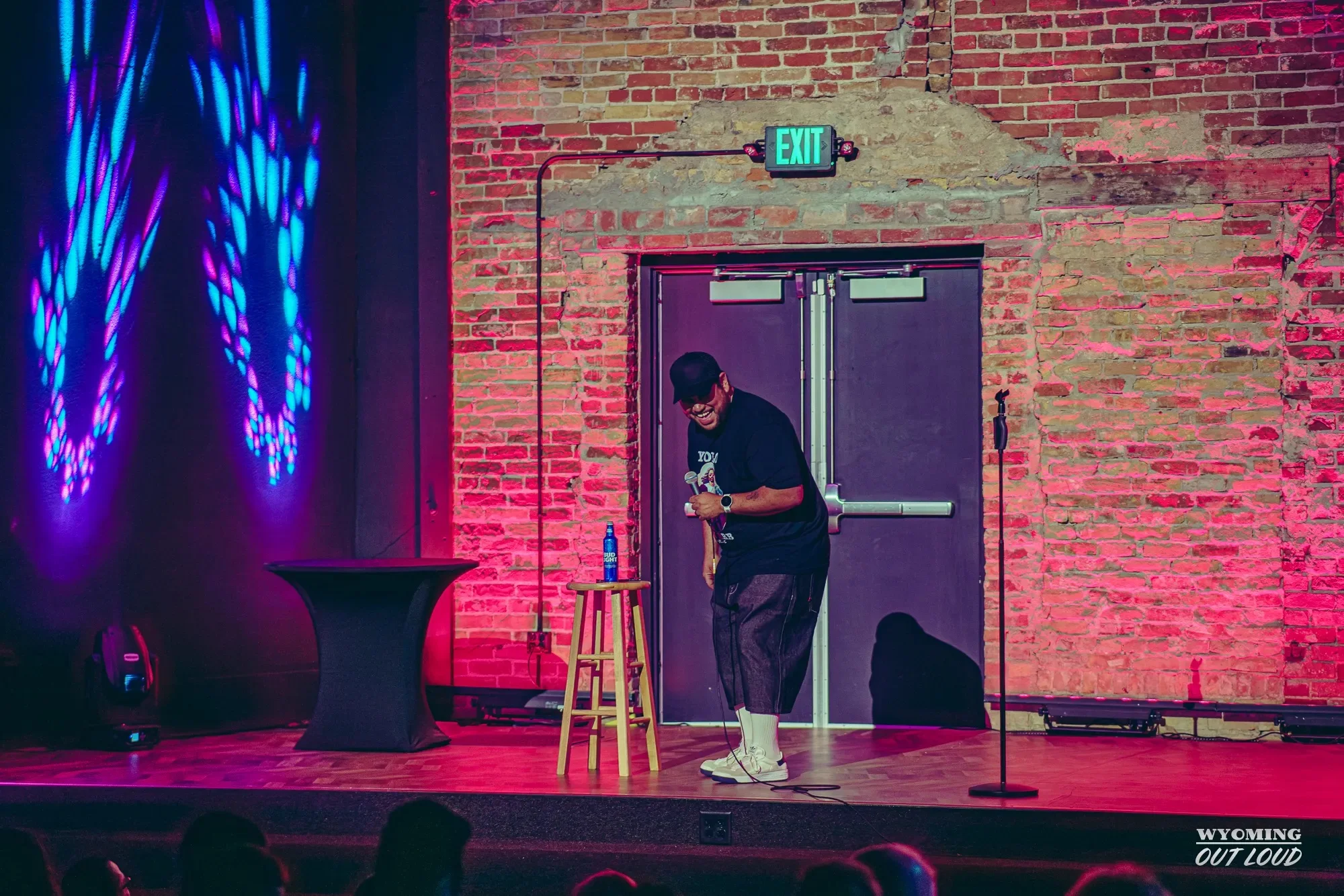 Comedian performing on The Rialto brick-wall stage
